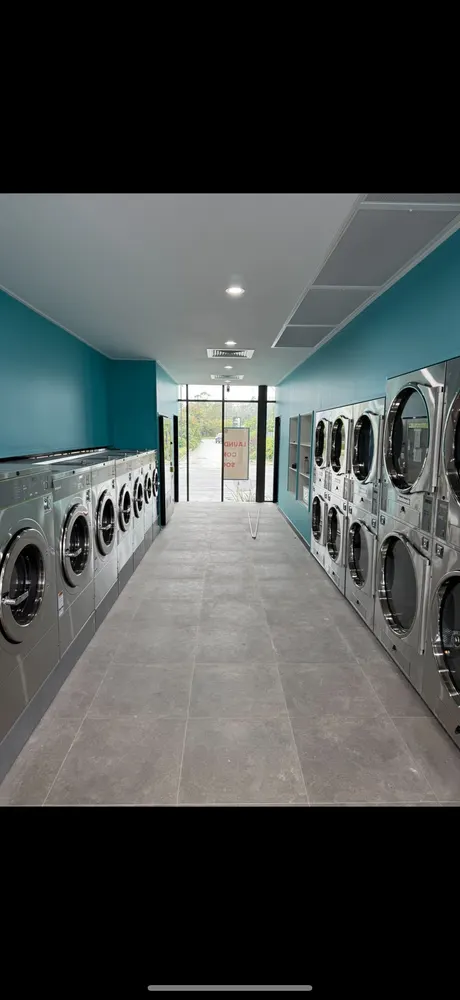 Completed commercial laundromat with plumbing services integrated into the fit-out